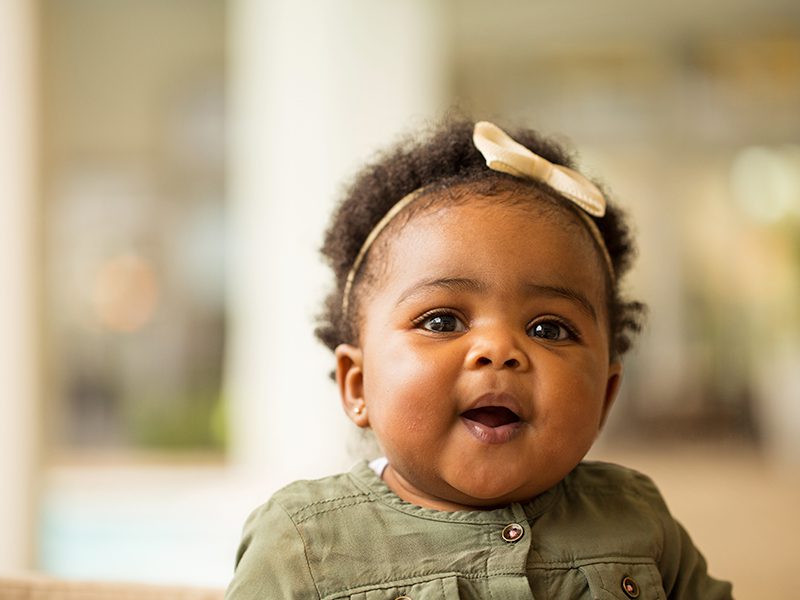 Little girl with a cute ribbon smiling