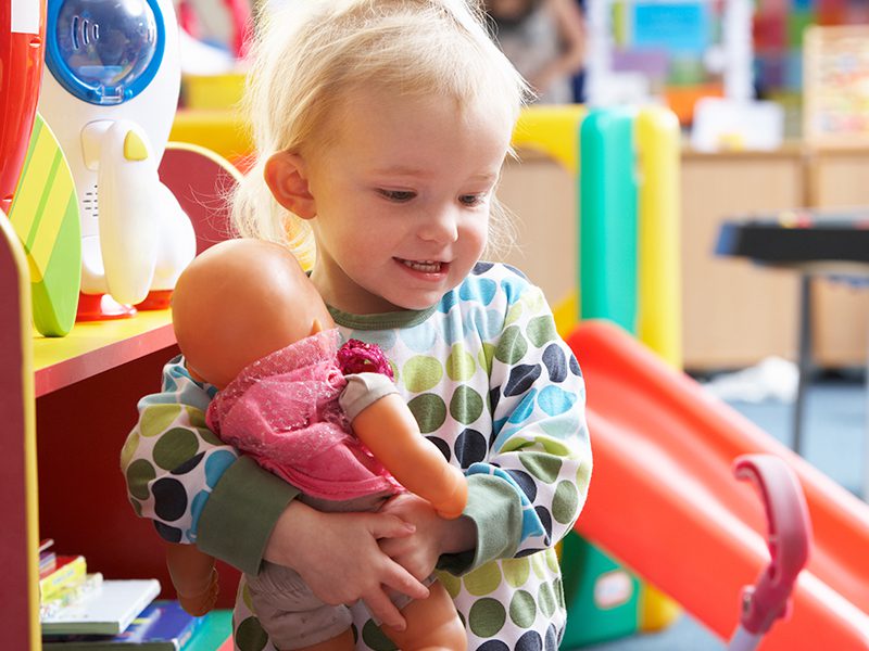 Little girl playing with a doll