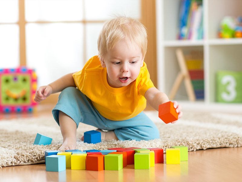 Little kid playing with cubes