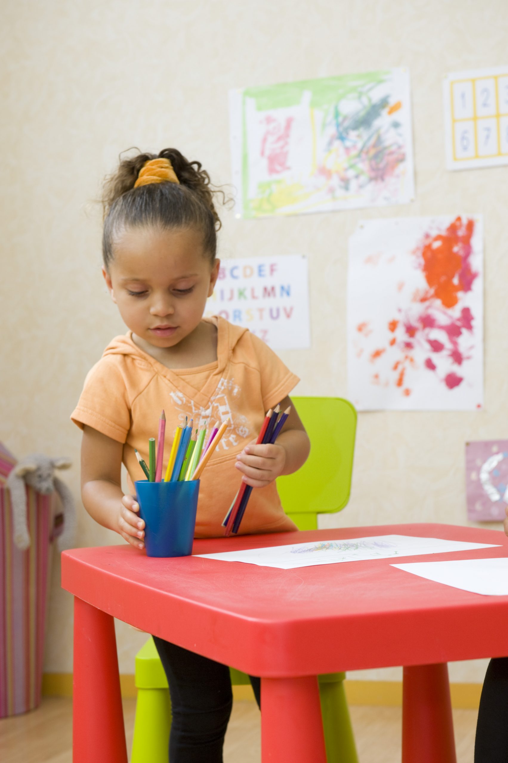 Little girl selecting colored pencils